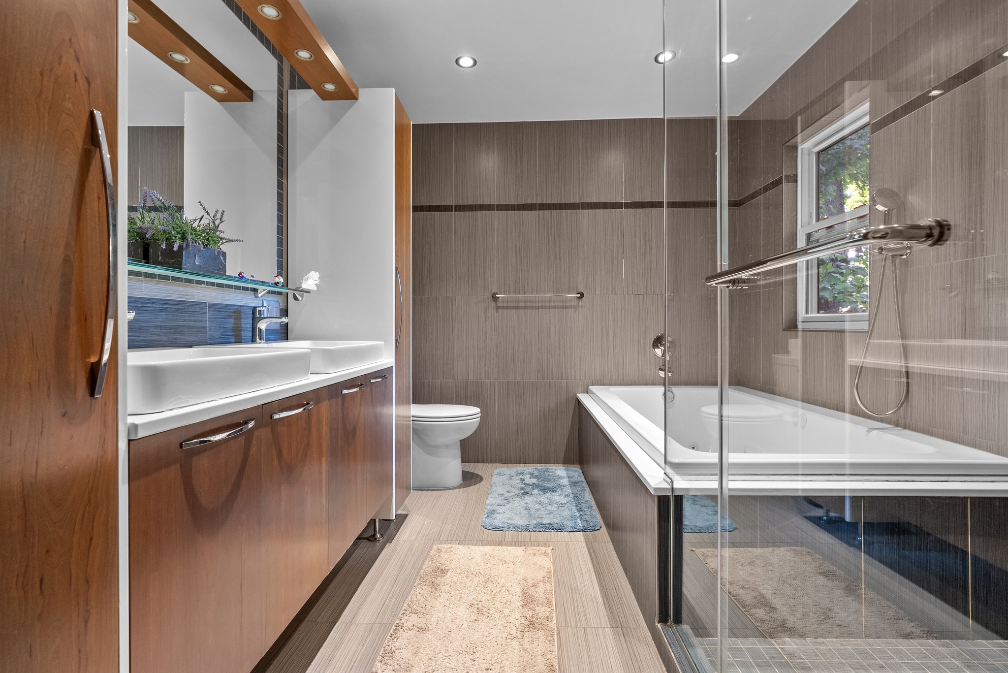 The primary bedroom suite upstairs includes a quiet seating area, a large walk-in closet, and an updated bathroom—very relaxing. There are also three other comfortable bedrooms, each offering privacy.