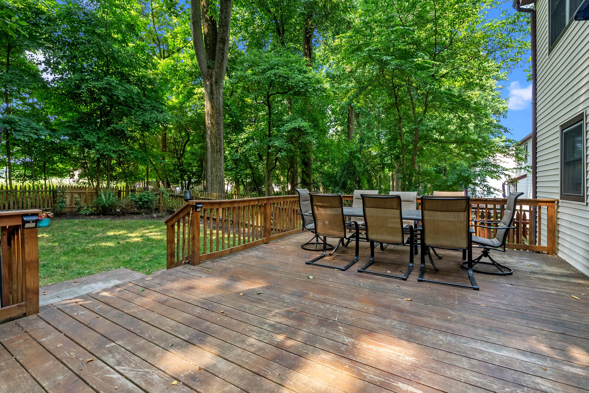 Outside, there's a large cedar wood deck and a spacious, fenced backyard—perfect for outdoor entertaining. 